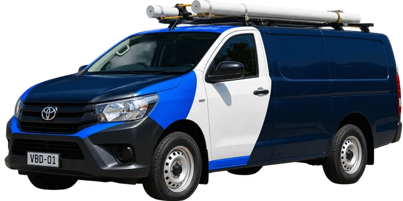 A licensed Pennant Hills plumbing van loaded with pipe on the roof rack